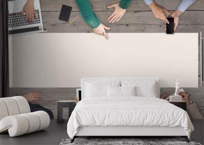 Business Teamwork concept - top view of eight business people. White blank sheet of paper in the middle of the wooden table. Wall mural