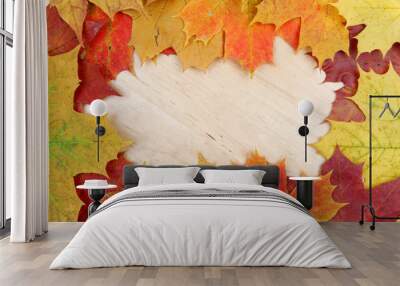 frame composed of colorful autumn leaves on wooden background te Wall mural