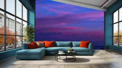 Beautiful clouds in a colorful sky at sunset in summer over the sea Wall mural