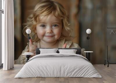 Blond toddler in art class giving a cheerful thumbs up gesture Wall mural