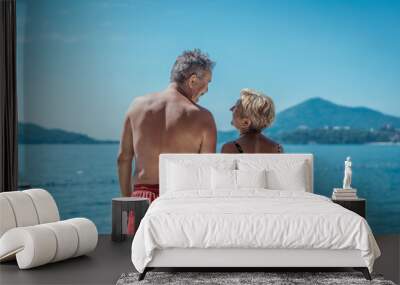 Beautiful older couple in love on vacation enjoying the summer time on beach Wall mural