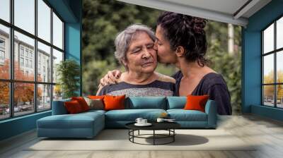 Young woman and her grandmother, very old woman. Two generations. Family love. Wall mural