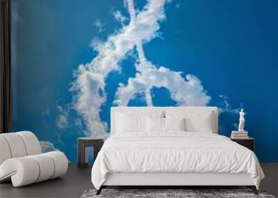 Clef made of clouds in blue sky. A musical symbol used to indicate which notes are represented by the lines and spaces on a musical staff Wall mural