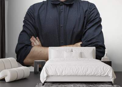 Cropped portrait of young businessman wearing formal with crossed arms on the white background. Business concept. Selective focus and shallow DOF Wall mural