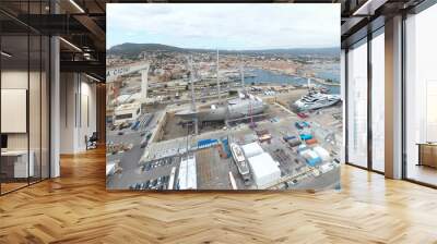 Aerial view of sea dry dock in La Ciotat city, France, the cargo crane, boats on repair, a luxury sail yacht and motor yacht, mountain is on background, shipyard Wall mural