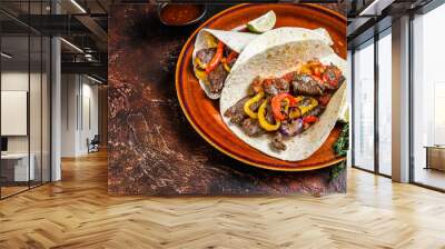 Fajitas Tortilla wraps with beef meat steak stripes, sweet pepper and onions. Dark Wooden background. Top view. Copy space Wall mural