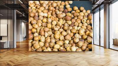 fry hazelnuts in a frying pan. fresh nuts in the pan. Wall mural