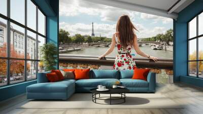 Girl looking over Paris in summer Wall mural