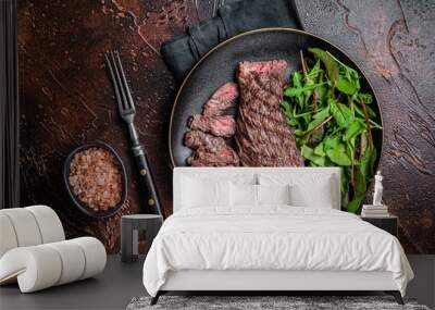 Juicy Grilled  Machete skirt beef meat steak on plate with salad. Dark background. Top view Wall mural