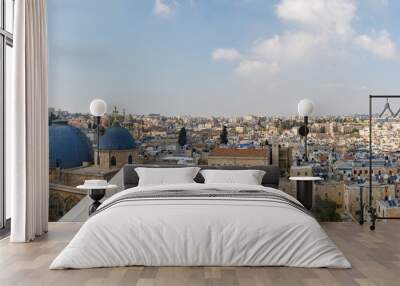 View from top of church on wide panorama of eastern part of old city of Jerusalem with two domes and belfry of the Church of the Holy Sepulchre Wall mural