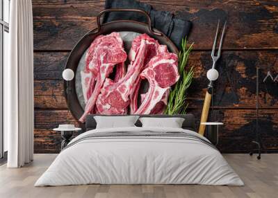 Raw lamb mutton chop steaks, fresh meat cutlets on butcher table. Black background. Top view Wall mural