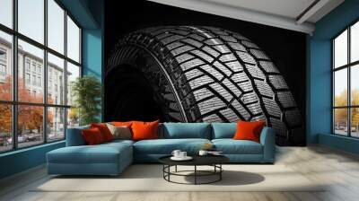 winter tire, friction for snow and ice. asymmetrical tread pattern. close-up on a black background Wall mural