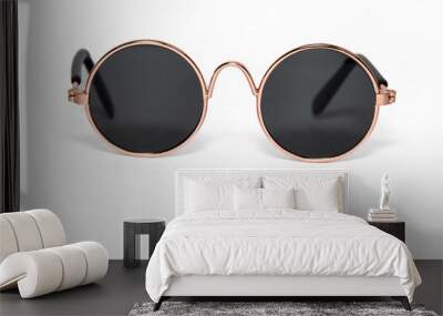 Round sunglasses in a gold frame close-up on a white background Wall mural