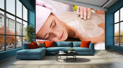 Young woman with slimming body thermal mask on her back. Spa Tre Wall mural