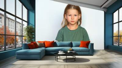 serious child looks at the camera. place for text. portrait of a girl on a white background. collect Wall mural