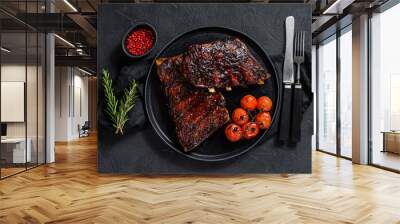 Spicy hot grilled spare pork ribs. Barbecue meat. Black background. Top view Wall mural