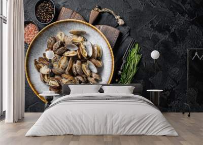 Steamed cooked shells Clams vongole in a plate with herbs. Black background. Top view. Copy space Wall mural