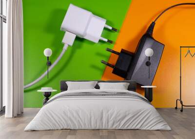 universal white and black charger on orange and green background Wall mural