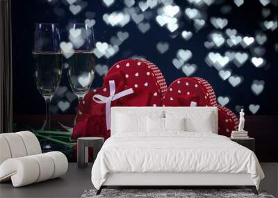 Valentine's Day. Composition: two red gift boxes with bows, two champagne glasses, heart-shaped chocolates, three burgundy-red roses on a dark white heart-shaped background. Wall mural