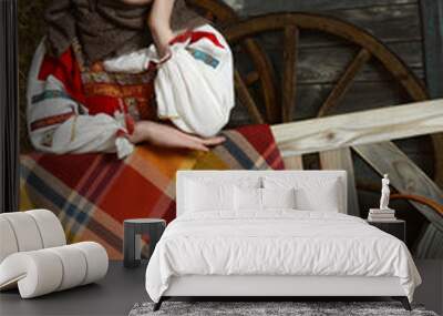 Beautiful girl in russian costume sitting in a traditional interior Wall mural