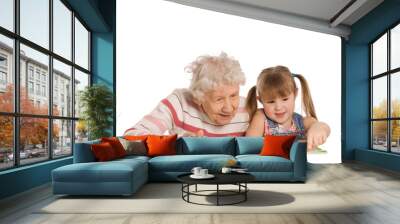 The grandmother with the grand daughter read the book Wall mural