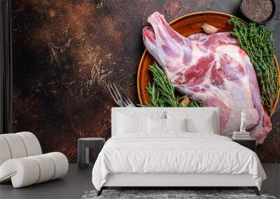 Whole fresh Raw goat shoulder meat on a plate. Dark wooden background. Top view. Copy space Wall mural