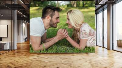 Young happy couple being in love, holding hands Wall mural