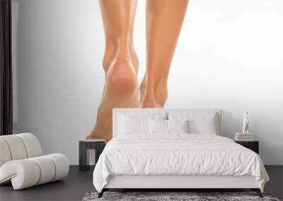 Back view of a beautifully cared female bare feet on a white background. Wall mural