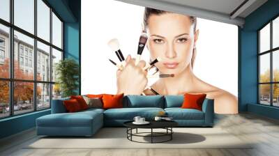 Beautiful woman with makeup brushes near her face Wall mural