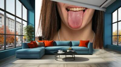 closeup of a young woman with her tongue out Wall mural