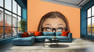 half portrait of a young girl with glasses looking up Wall mural