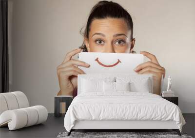 happy and smiling girl with a smile painted on paper Wall mural