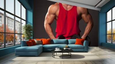 muscular man in red shirt posing with weights Wall mural