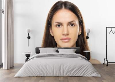 portrait of a young serious woman without makeup on a white studio background. Wall mural