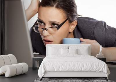 sleepy and tired business woman on laptop, holding a coffee mug Wall mural