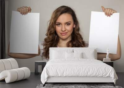 smiling girl holding two blank sheets of paper Wall mural