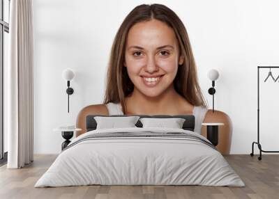 smiling young woman without make-up, looking at the camera Wall mural