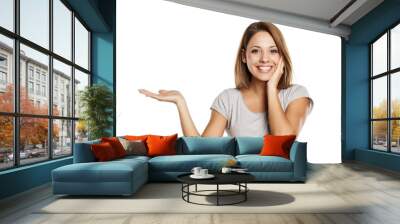 young beautiful woman in gray shirt , holding imaginary object on the palm. isolated on white Wall mural