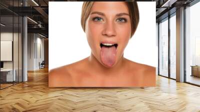 young beautiful woman sticking out her tongue Wall mural