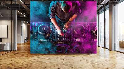 Charismatic disc jockey at the turntable. DJ plays on the best, famous CD players at nightclub during party. EDM, party concept. Wall mural