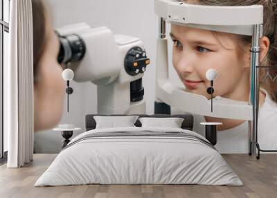 Examination of the child using a slit lamp. Microscope and focused light source. A device for high-precision examination of the eye to determine the condition of the lens. Wall mural