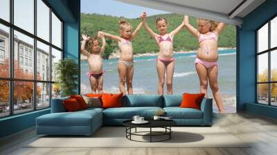 children with sun lotion on the beach Wall mural