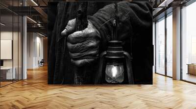 mans hand holding a walking stick with a lantern Wall mural