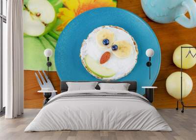 Animal face sandwich for kids healthy breakfast on blue plate, top view. Funny children meal for breakfast. Owl sandwich Wall mural