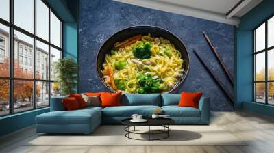 Asian noodle soup Ramen with vegetables and pork in bowl and chopsticks on textured background Wall mural