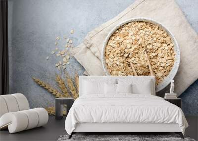 Oat flakes, oats or rolled oats in bowl. Table top view Wall mural