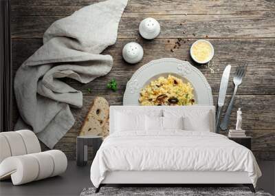 Pearl barley mushroom risotto on wooden background. Top view Wall mural