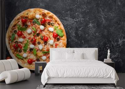 Tasty pizza on black concrete background, top view and copy space for text. Italian pizza with tomato, mozzarella cheese, black olives and arugula Wall mural