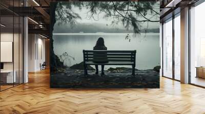 Depressed and sad young woman with long hair casual clothes sitting alone on bench in the park, back view, looking at lake city landscape, in deep thoughts, sadness, mist, autumn, winter, AI Generated Wall mural