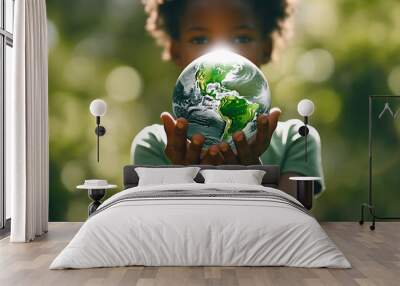 Hands of a African American child holding crystal glowing globe, planet Earth at a sunny green meadow background, copyspace, taking care Ecology, sustainable nature, conversation concept, AI Generated Wall mural